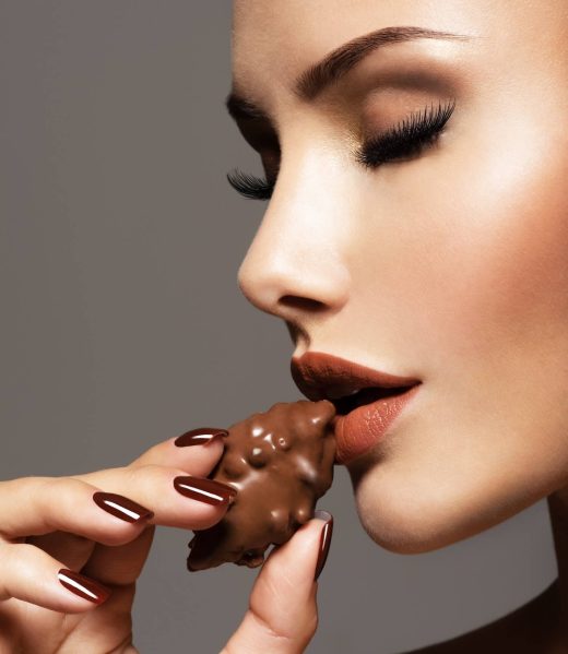 glamour-beautiful-woman-holds-and-eats-chocolate-2023-11-27-05-12-51-utc (1)